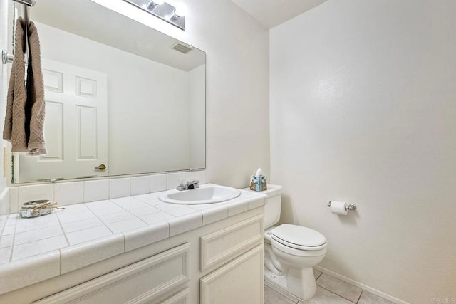 bathroom featuring vanity, toilet, and tile patterned flooring