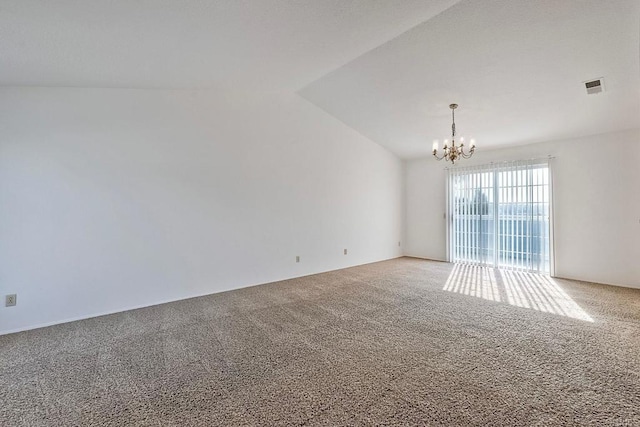 unfurnished room featuring an inviting chandelier, vaulted ceiling, and carpet floors