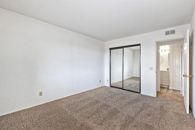 unfurnished bedroom with carpet floors and a closet