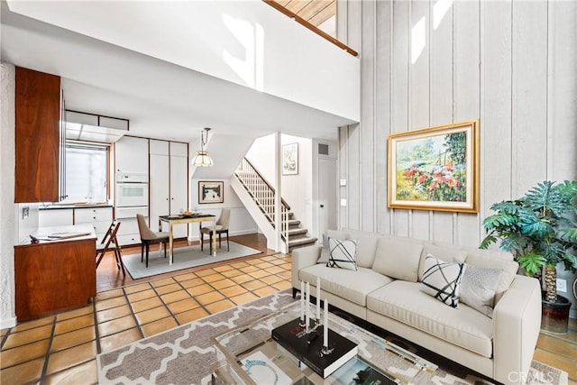 tiled living room with a high ceiling