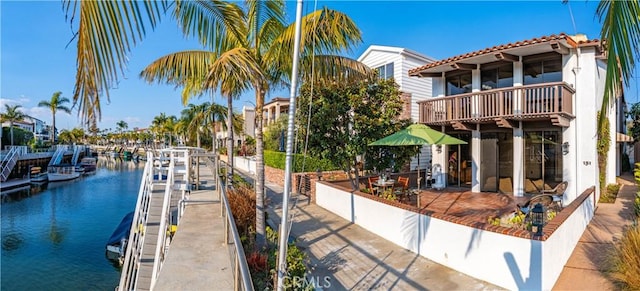 dock area featuring a balcony and a water view