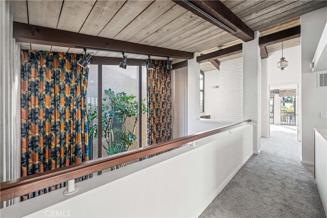 hall featuring wood ceiling, beam ceiling, and carpet