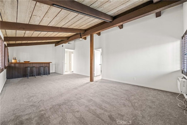 unfurnished living room with indoor bar, carpet flooring, lofted ceiling with beams, and wooden ceiling