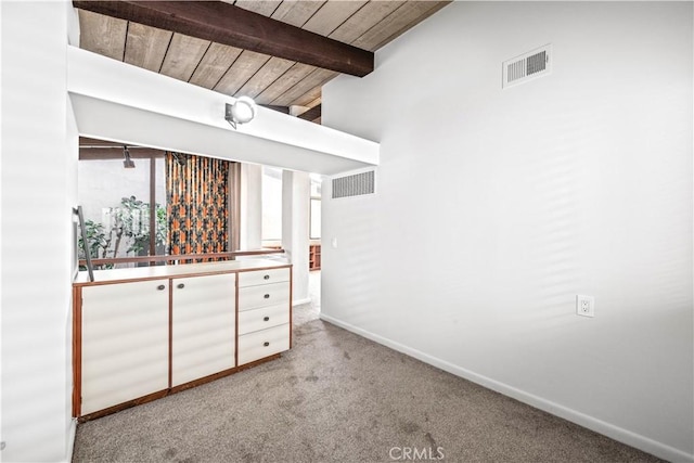 bar with beamed ceiling, light carpet, and wood ceiling