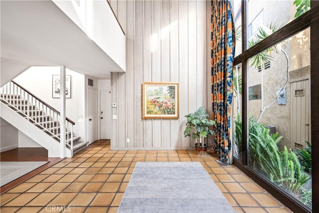 tiled foyer entrance featuring a high ceiling