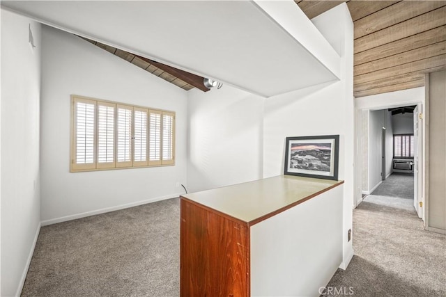 interior space with vaulted ceiling, carpet, and a healthy amount of sunlight