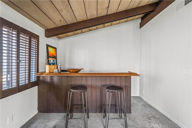 bar with beamed ceiling, light colored carpet, and wooden ceiling