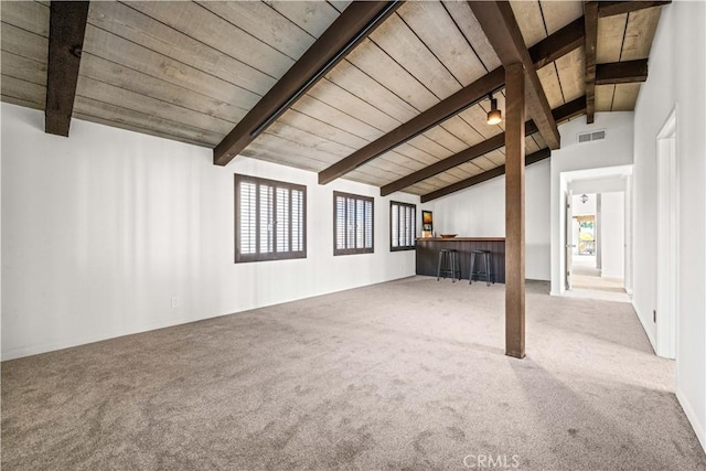 interior space featuring lofted ceiling with beams, carpet floors, and wooden ceiling