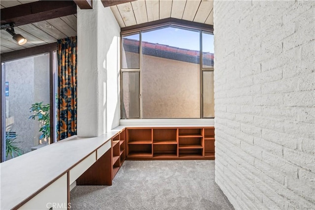 interior space with vaulted ceiling and light carpet