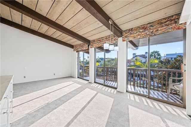 unfurnished sunroom featuring beam ceiling and wooden ceiling