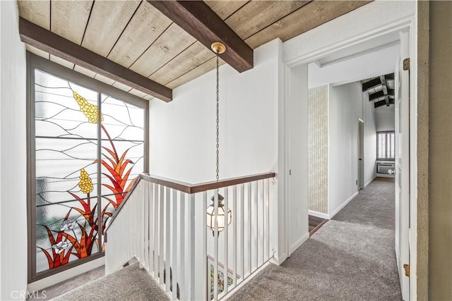 corridor featuring carpet, wood ceiling, and beam ceiling