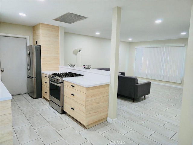 kitchen with appliances with stainless steel finishes and light brown cabinetry