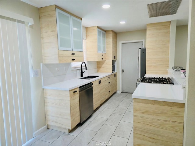 kitchen featuring sink, backsplash, stainless steel appliances, light tile patterned flooring, and light brown cabinetry