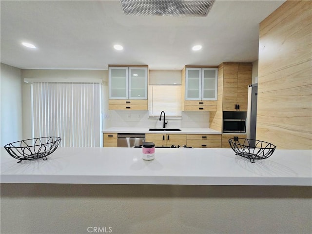 kitchen with sink, stainless steel appliances, and light brown cabinets