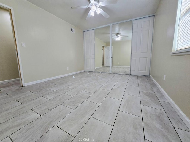 unfurnished bedroom with light tile patterned flooring, ceiling fan, and a closet