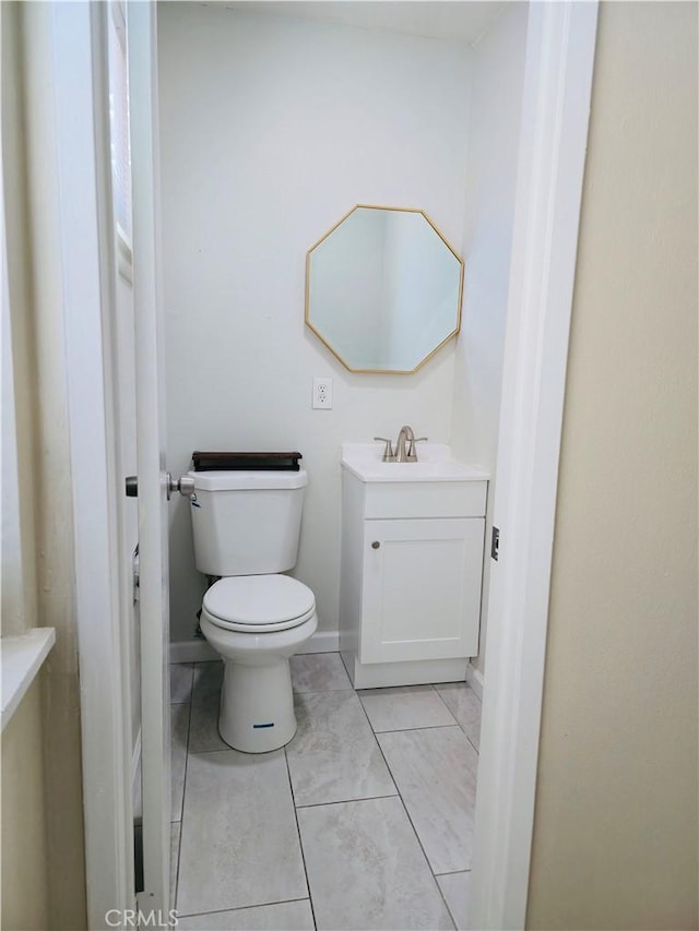 bathroom with vanity, tile patterned floors, and toilet