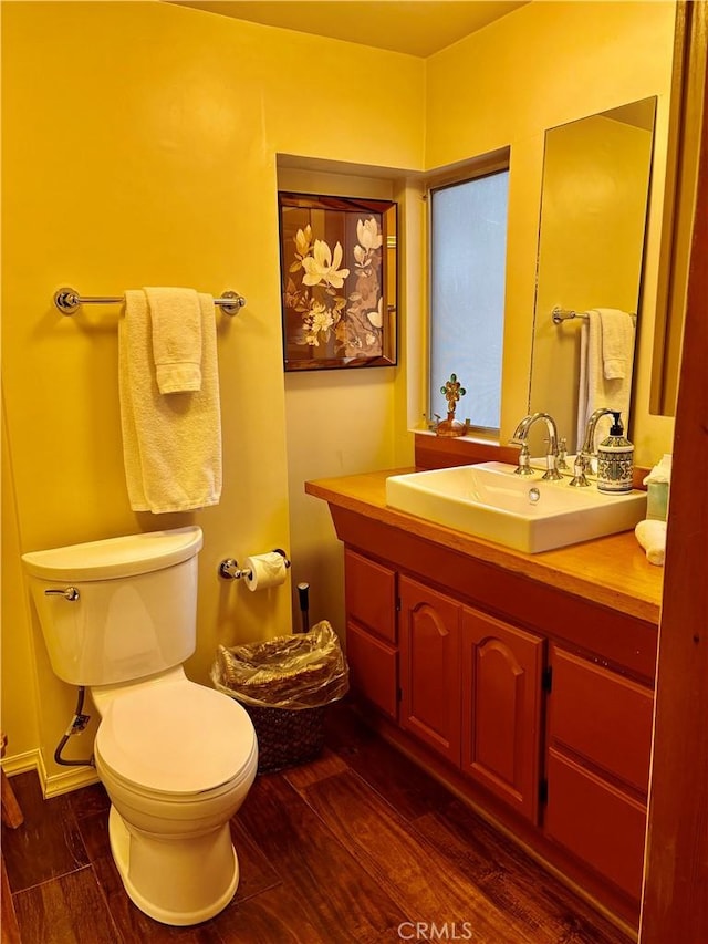 bathroom featuring vanity, hardwood / wood-style floors, and toilet