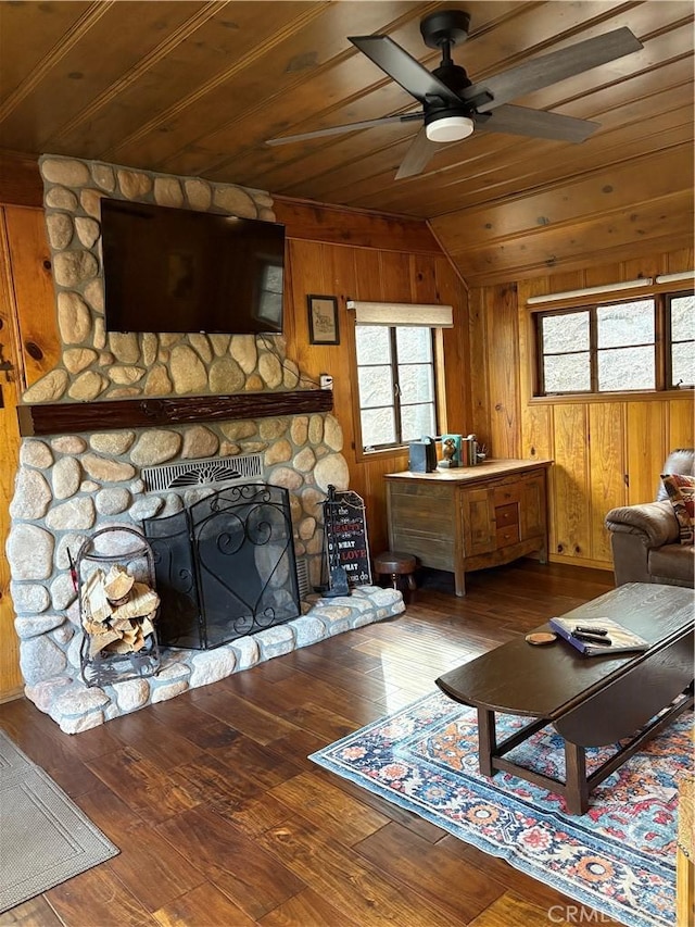 living room featuring lofted ceiling, hardwood / wood-style flooring, wooden walls, and wooden ceiling