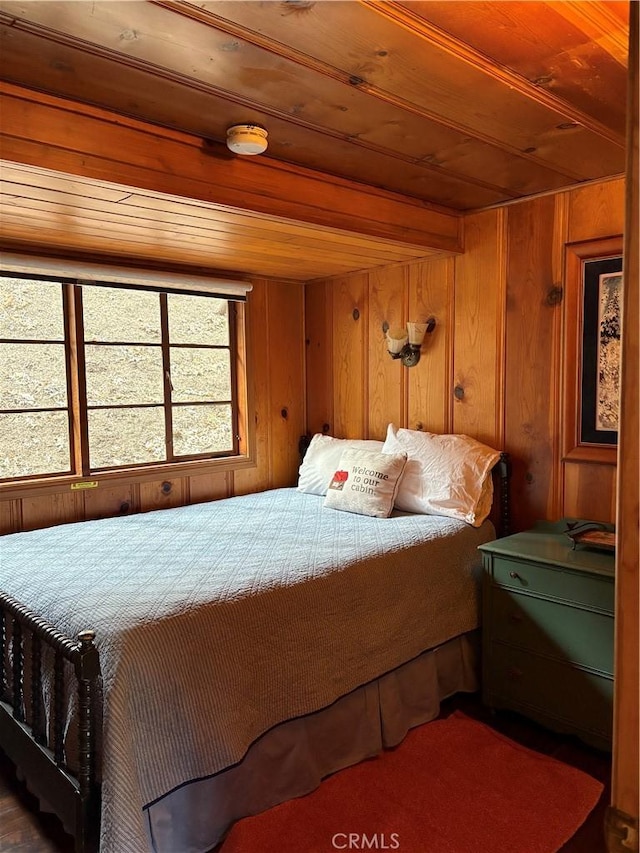 bedroom with wooden walls and wood ceiling