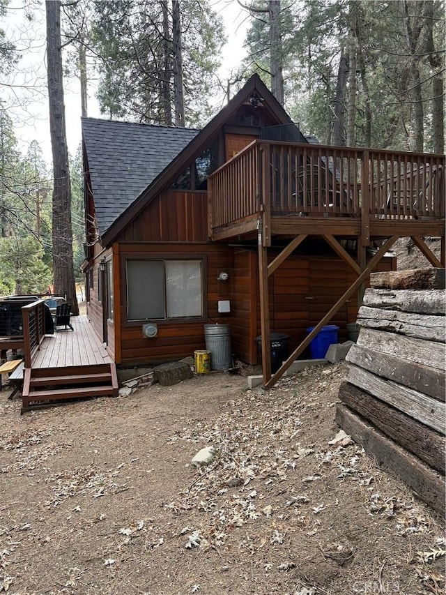 back of property featuring a wooden deck