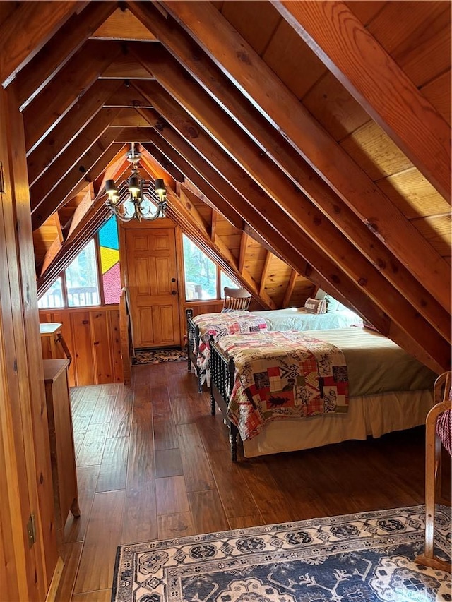 bedroom featuring vaulted ceiling, dark wood-style floors, and wood walls