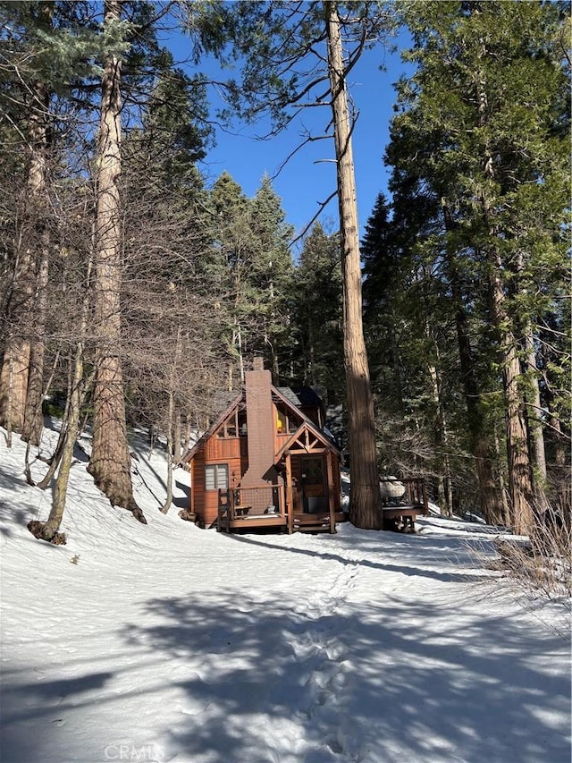 view of front of home featuring a deck and a chimney