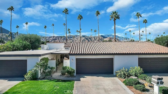 view of front facade featuring a mountain view and a garage