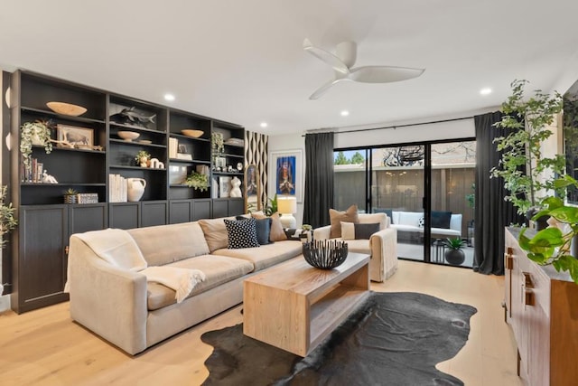 living room featuring ceiling fan and light wood-type flooring