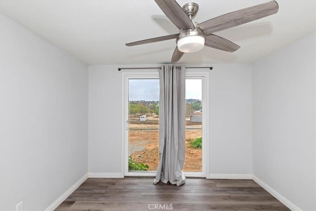 spare room featuring ceiling fan and dark hardwood / wood-style floors