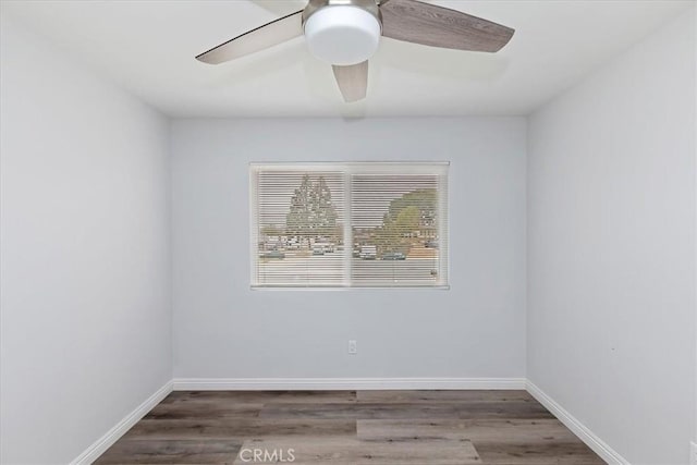 spare room with ceiling fan and dark hardwood / wood-style flooring