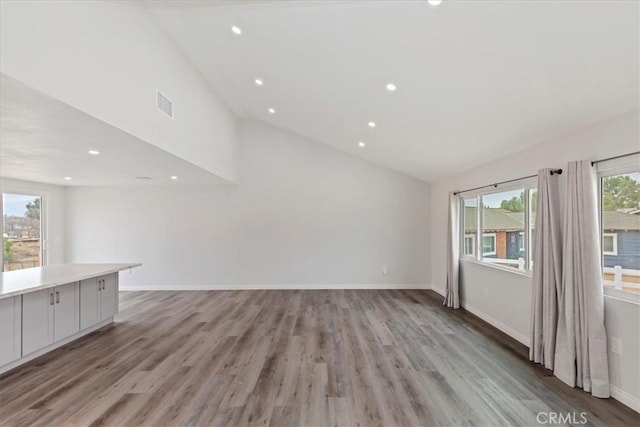 unfurnished living room with lofted ceiling and light hardwood / wood-style floors