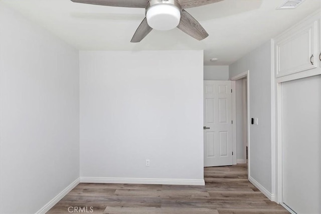 unfurnished room with light hardwood / wood-style floors and ceiling fan