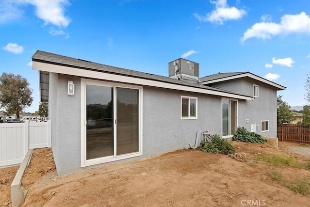 back of house featuring central AC