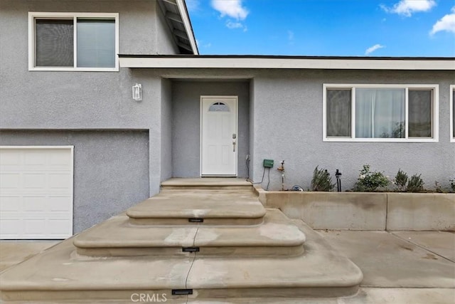 doorway to property with a garage