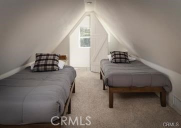 carpeted bedroom with vaulted ceiling