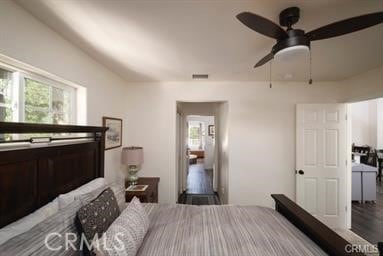 bedroom with ceiling fan and multiple windows