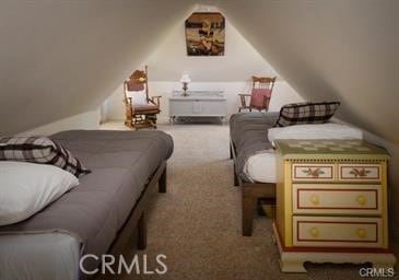 bedroom featuring lofted ceiling and carpet flooring