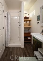 bathroom featuring hardwood / wood-style flooring and a shower with shower curtain