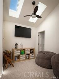 living room with ceiling fan and vaulted ceiling with skylight