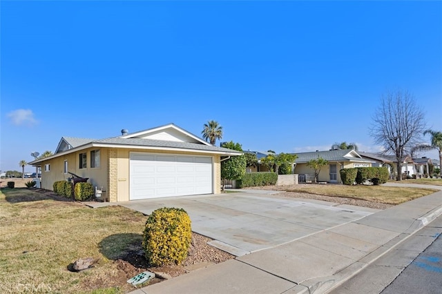 single story home with a garage and a front lawn