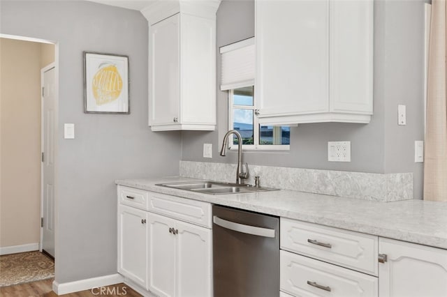 kitchen with white cabinetry, sink, light hardwood / wood-style floors, and dishwasher