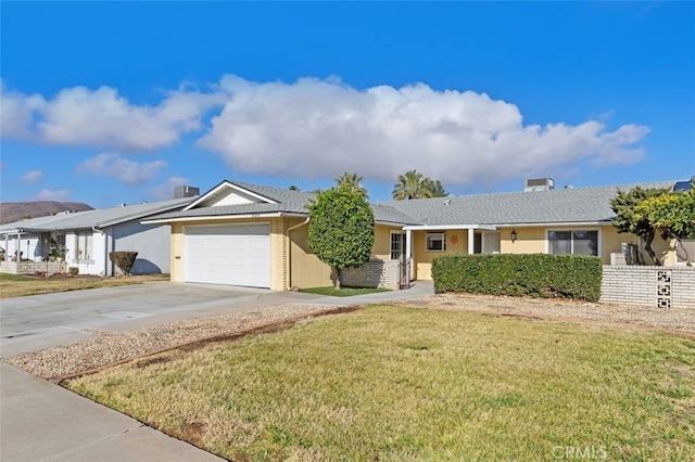 ranch-style home with a garage and a front lawn