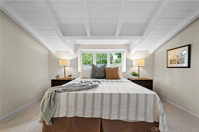 bedroom with carpet floors, vaulted ceiling with beams, and wooden ceiling