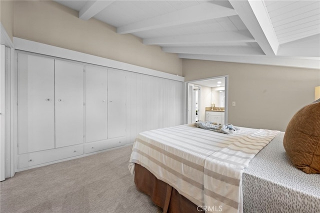 carpeted bedroom featuring lofted ceiling with beams