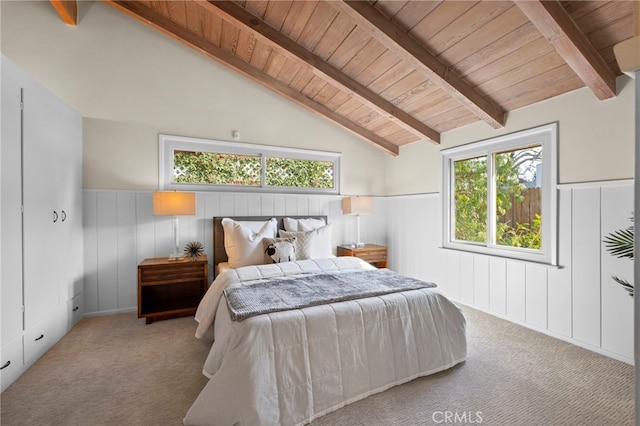 carpeted bedroom featuring vaulted ceiling with beams and wood ceiling