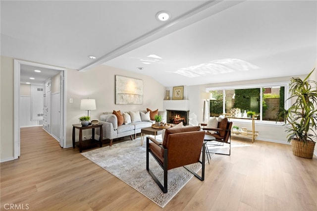 living room with vaulted ceiling and light wood-type flooring