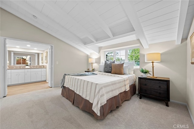 carpeted bedroom featuring ensuite bathroom and vaulted ceiling with beams