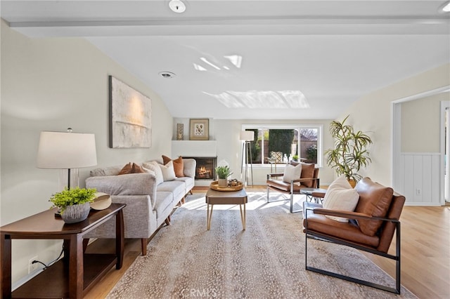 living room featuring vaulted ceiling and light wood-type flooring