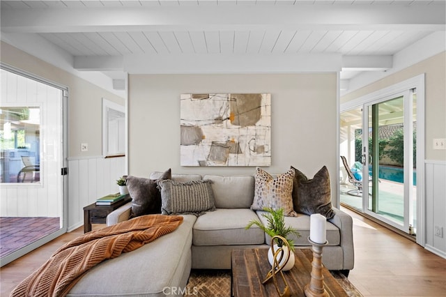 living room with beamed ceiling, wood-type flooring, and wooden ceiling