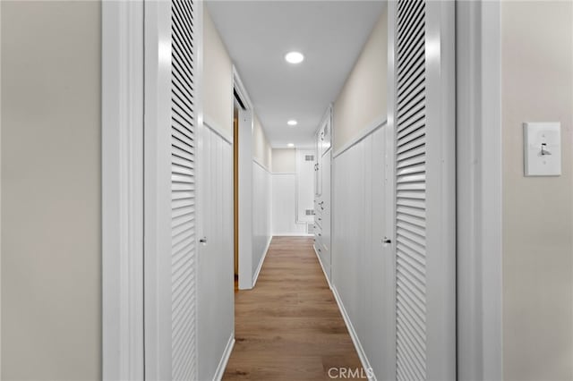 corridor with light hardwood / wood-style floors